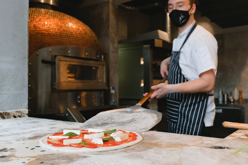 Mod Pizza team working together with fresh pizza ingredients